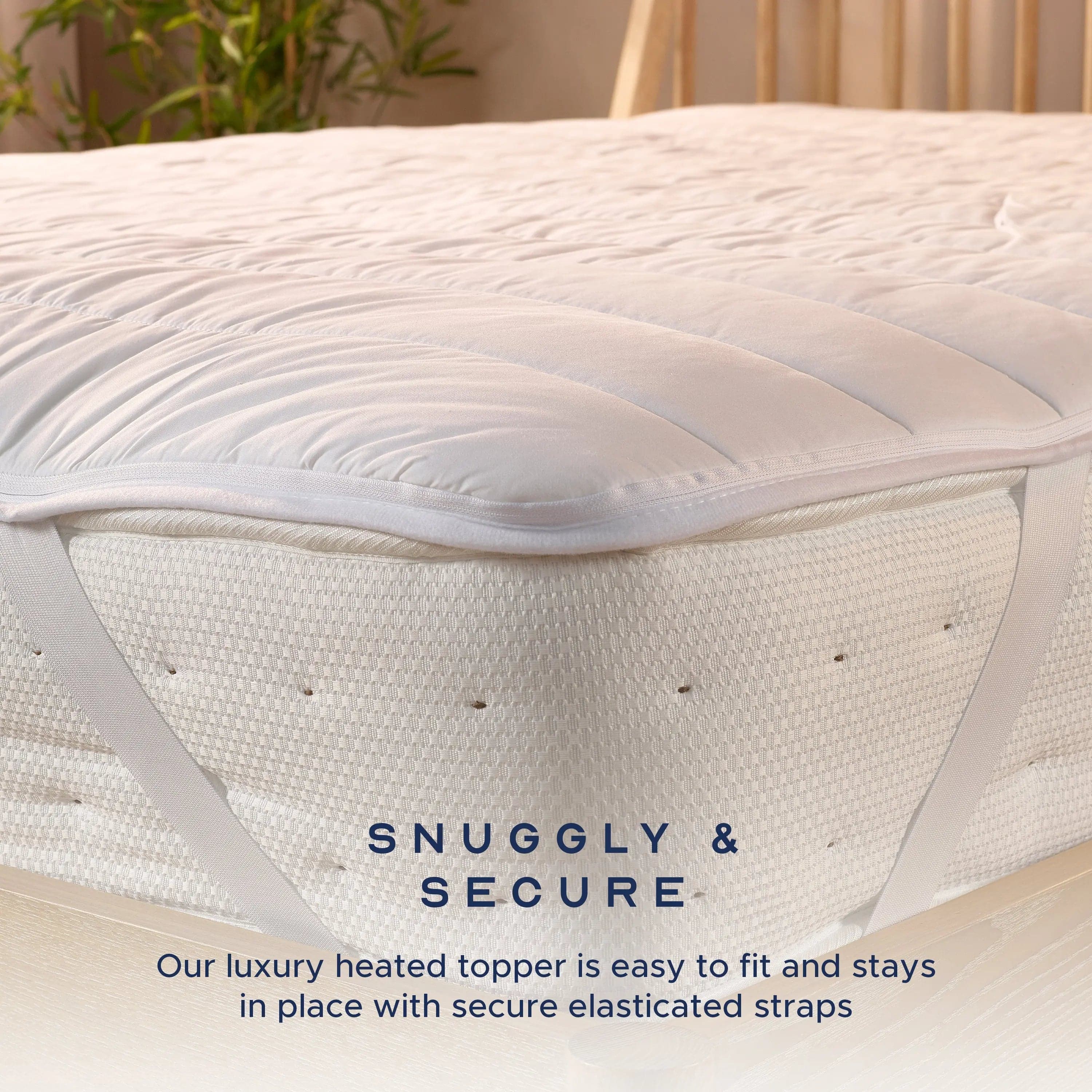 Elasticated straps holding the heated topper securely around the corner of a mattress.